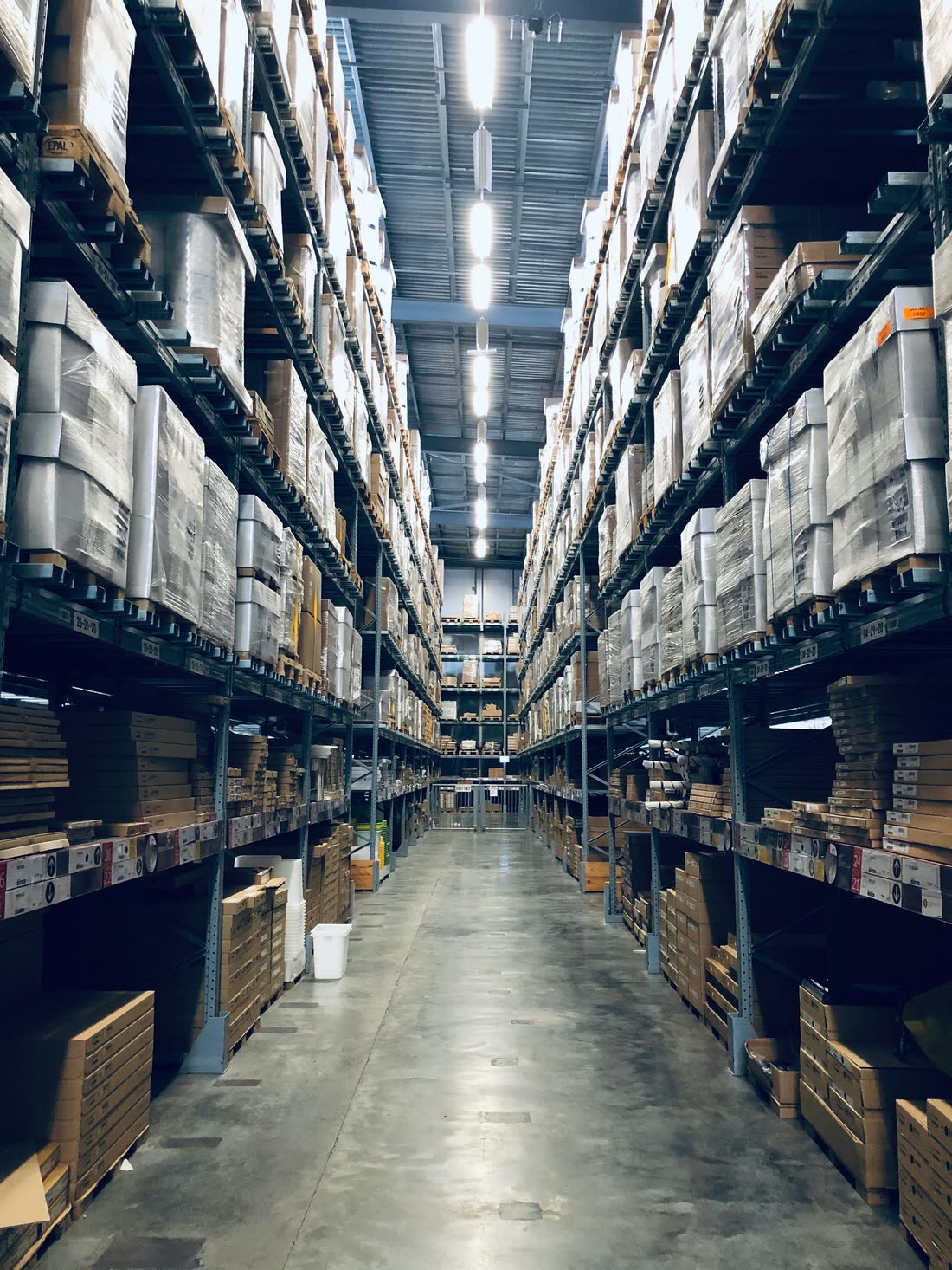 High-bay warehouse aisle with stored pallets